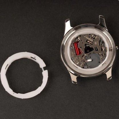 photo of movement spacer and of watch movement installed with spacer inside of a case side by side